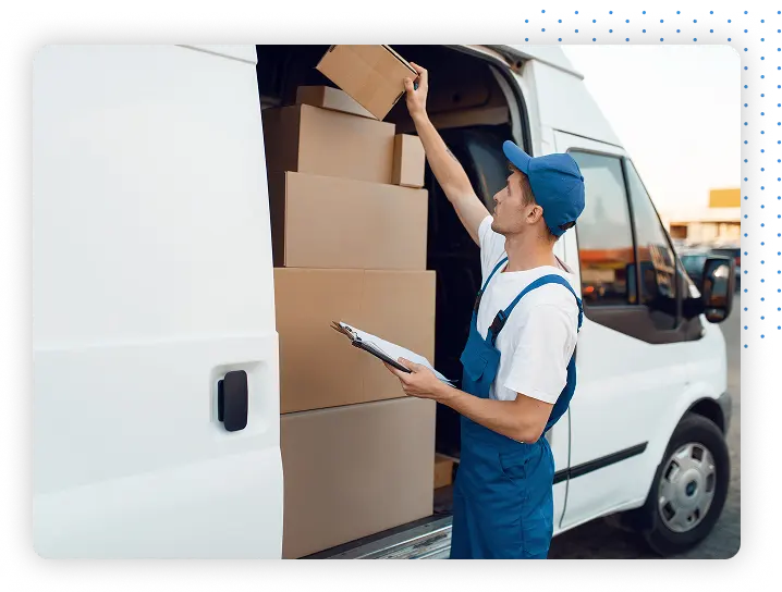 Person holding a clipboard inspecting boxes in a van