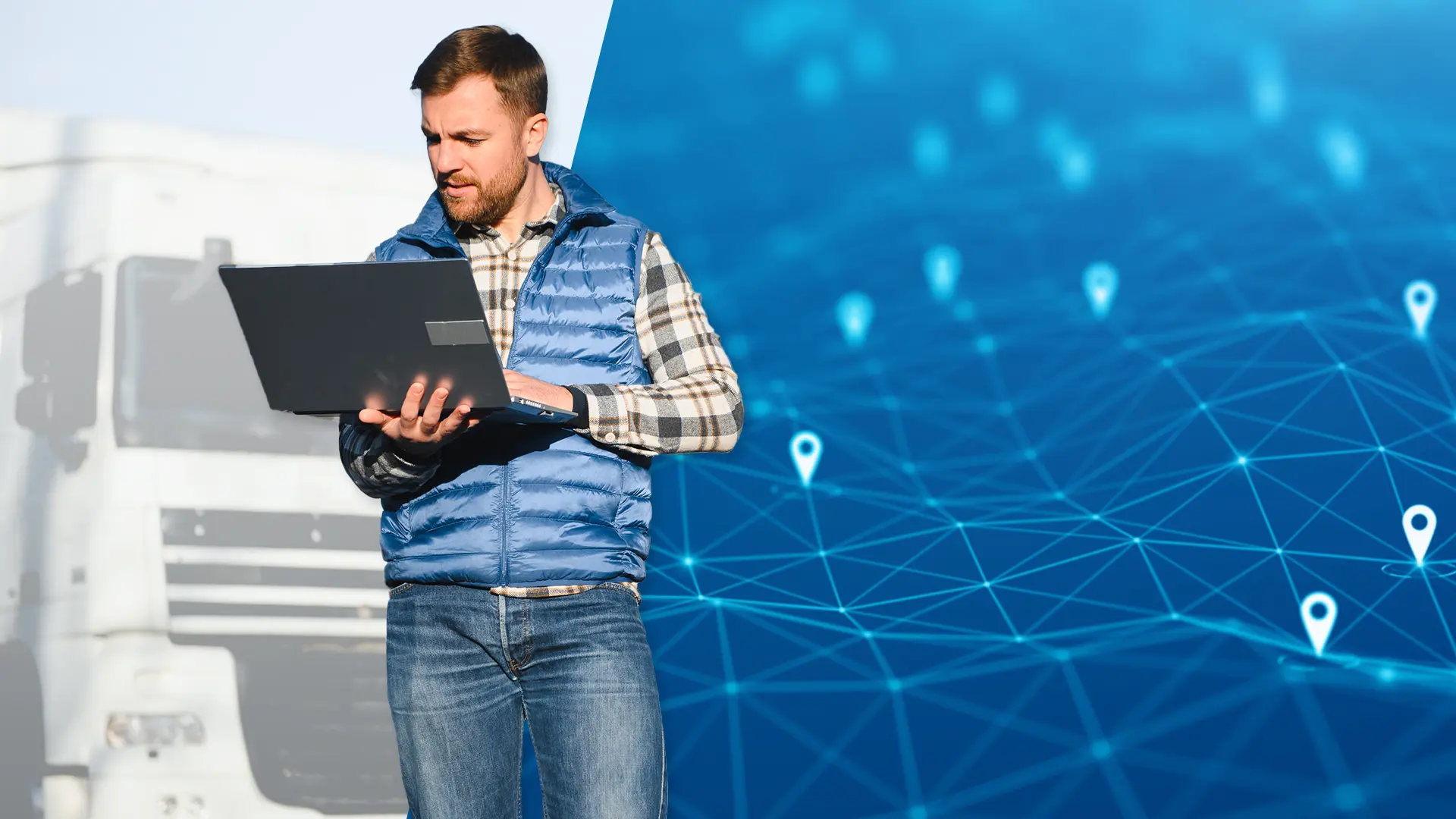 Man holding a laptop with a truck in the background