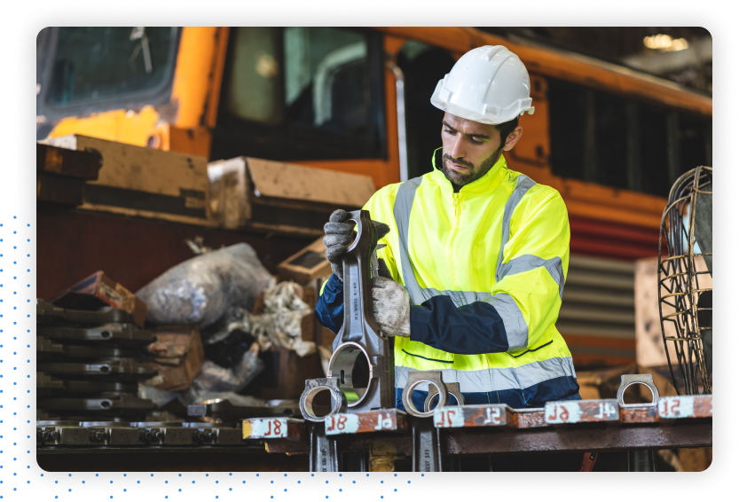 Worker Inspecting Machine Parts